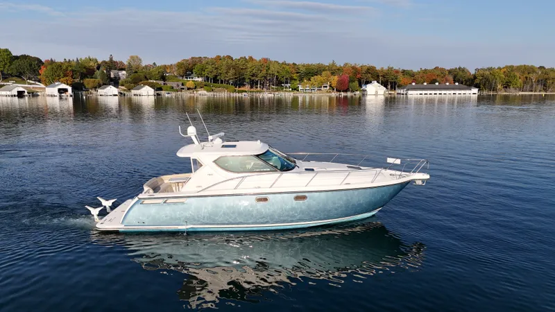 Slide: The Image of A 2006 Tiara Yachts 4300 Sovran cruising on a calm lake. - 15