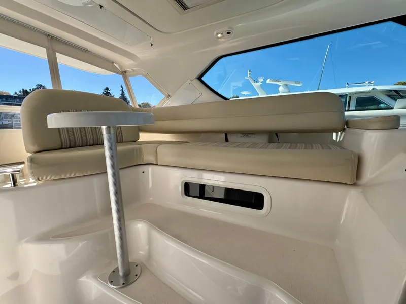 Slide: The Image of Interior of a 2006 Tiara Yachts 4300 Sovran with beige upholstery and a small table. - 22