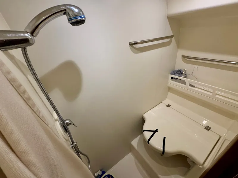 Slide: The Image of The shower in a 2006 Tiara Yachts 4300 Sovran with a handheld showerhead and bench. - 49