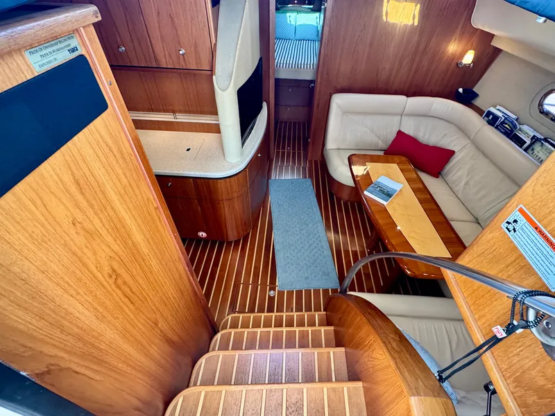 Slide: The Image of Interior of a 2006 Tiara Yachts 4300 Sovran with wood flooring and beige sofa. - 36