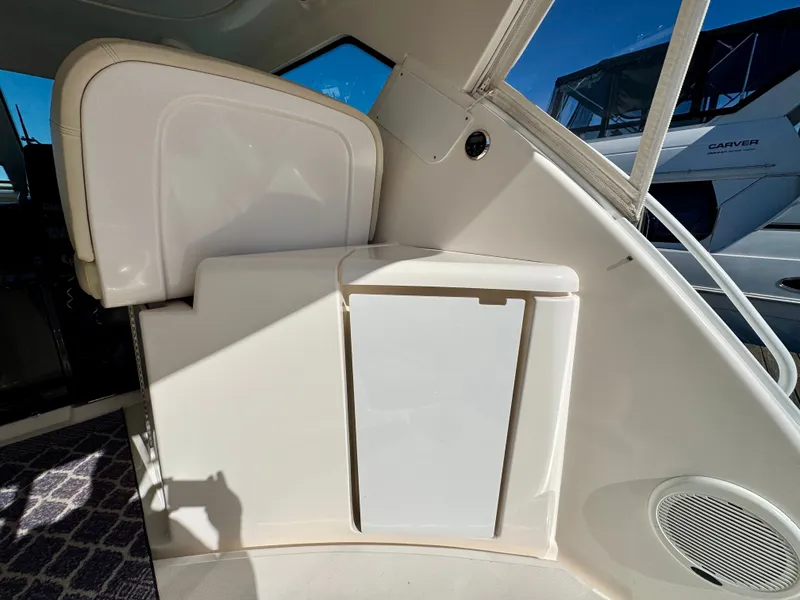 Slide: The Image of Interior of a 2006 Tiara Yachts 4300 Sovran with white seating and storage area. - 23