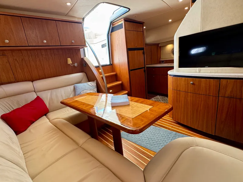 Slide: The Image of The 2006 Tiara Yachts 4300 Sovran interior features an elegant seating area with a wooden table. - 38