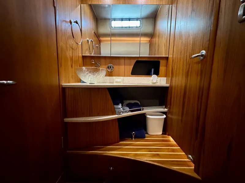 Slide: The Image of The image shows an elegant yacht bathroom with wood paneling and modern fixtures. - 47