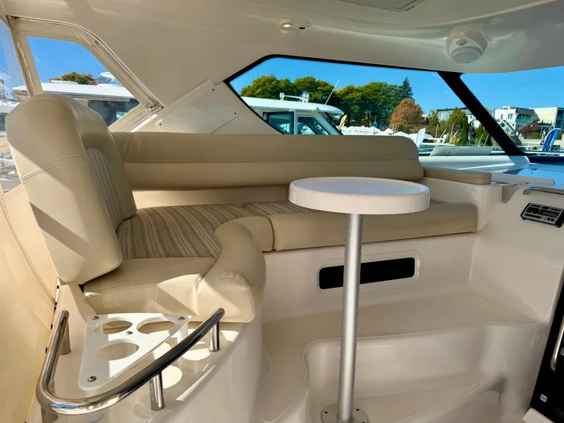 Slide: The Image of Interior of a 2006 Tiara Yachts 4300 Sovran with beige seating area and round table. - 21