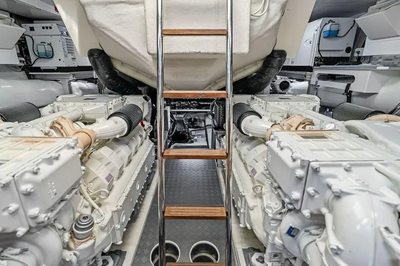 Slide: The Image of Engine room of 2022 Ferretti 850 yacht with dual engines and ladder access. - 63