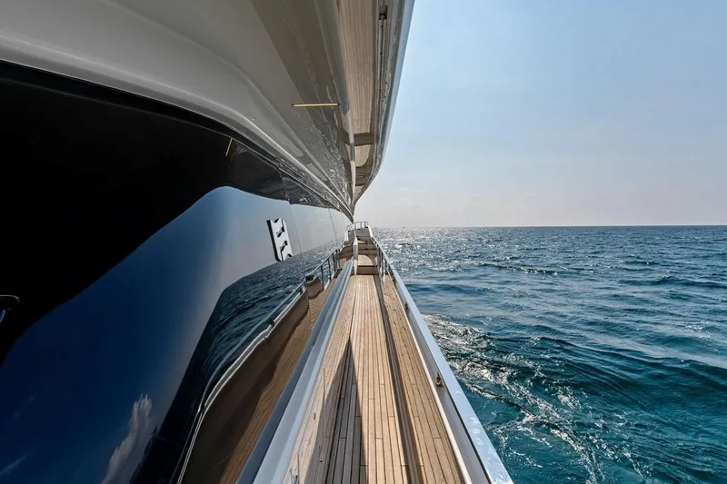 Slide: The Image of Side view of 2022 Ferretti 850 yacht cruising on open sea. - 21