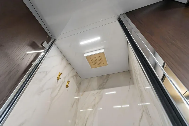Slide: The Image of Luxurious shower interior on 2022 Ferretti 850 yacht with marble walls and gold fixtures. - 51