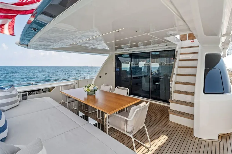 Slide: The Image of Luxurious 2022 Ferretti 850 yacht deck with dining area, ocean view, and elegant design. - 19
