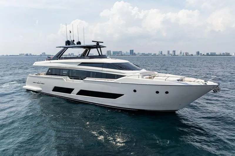 The Image of 2022 Ferretti 850 yacht cruising on open water with city skyline in background. - 0
