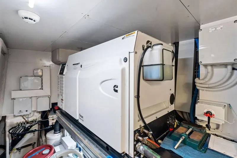 Slide: The Image of Engine room of 2022 Ferretti 850 yacht featuring Onan generator and electrical systems. - 69