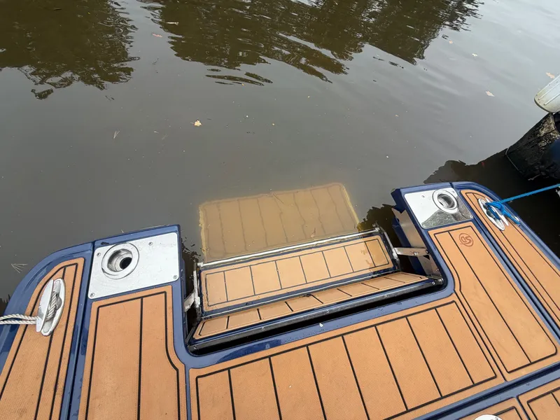 Slide: The Image of The image shows the stern of a Chaparral 267 SSX boat with a swim platform. - 20