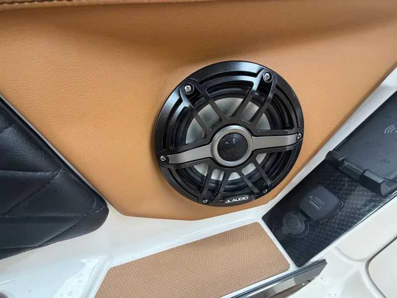 Slide: The Image of Close-up of a speaker in a boat with brown and black upholstery. - 21
