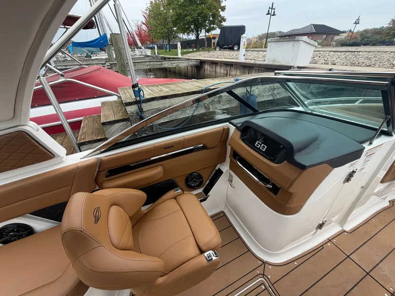Slide: The Image of The image shows the cockpit of a 2025 Chaparral 267 SSX with brown leather seats and a modern dashboard. - 14