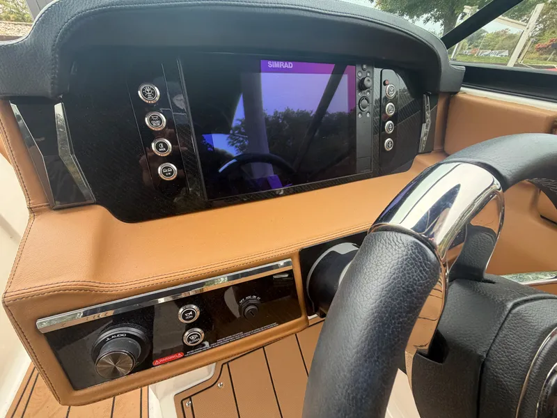 Slide: The Image of The image shows the dashboard of a Chaparral 267 SSX boat with a modern display and controls. - 13
