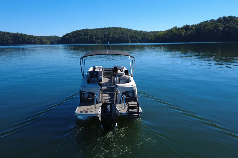 Slide: The Image of 2023 Barletta CORSA 23QSS pontoon boat on a serene lake. - 4