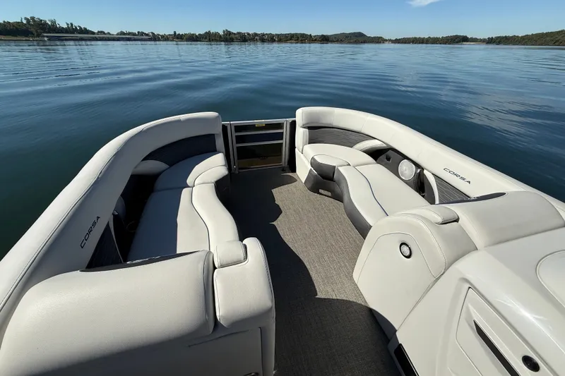 Slide: The Image of 2023 Barletta CORSA 23QSS pontoon boat interior with luxurious seating on a serene lake. - 6