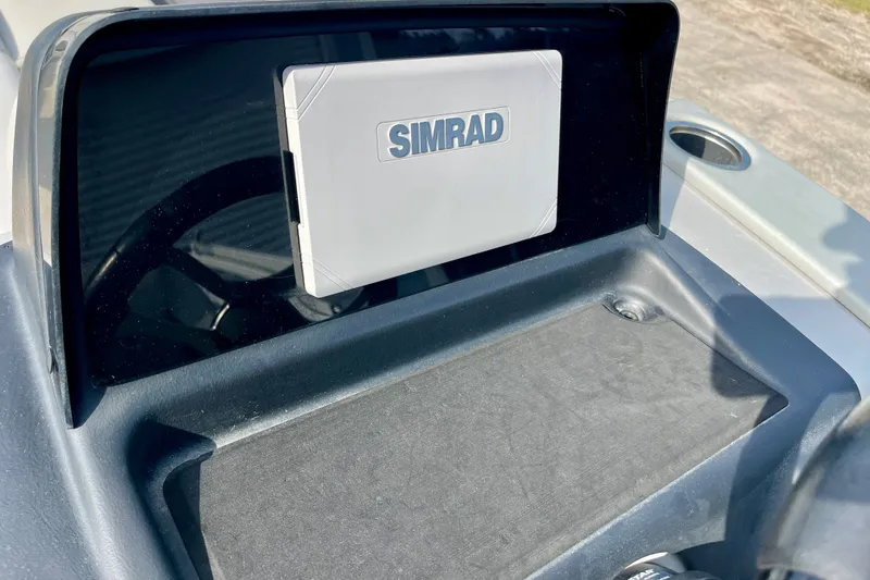 Slide: The Image of Simrad navigation system on 2024 Harris Cruiser 230 boat dashboard. - 7