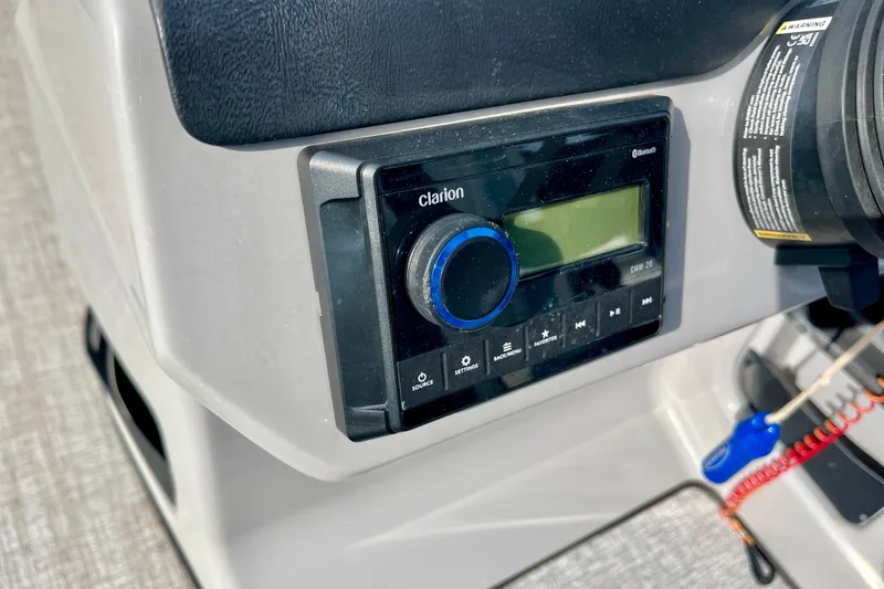 Slide: The Image of 2024 Harris Cruiser 230 dashboard with Clarion audio system and control panel. - 8