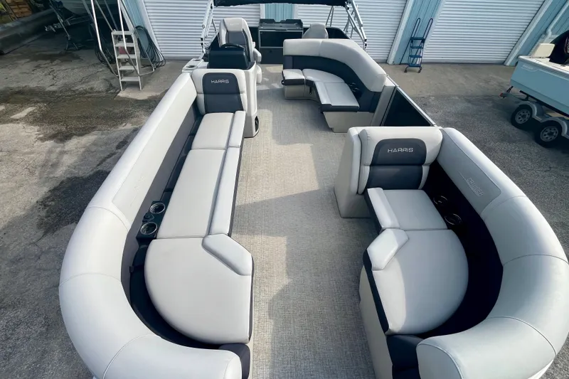 Slide: The Image of 2024 Harris Cruiser 230 pontoon boat with spacious seating and modern design. - 3