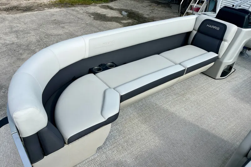 Slide: The Image of 2024 Harris Cruiser 230 boat interior with sleek, modern seating and integrated cup holders. - 1