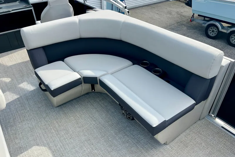 Slide: The Image of 2024 Harris Cruiser 230 boat interior with plush seating and cup holders. - 4