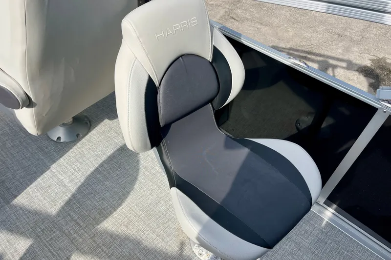 Slide: The Image of 2024 Harris Cruiser 230 boat seat with gray and black upholstery. - 9