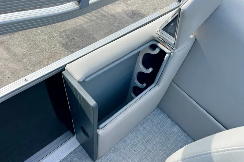 Slide: The Image of 2024 Harris Cruiser 230 boat interior with built-in cup holders and sleek seating design. - 11