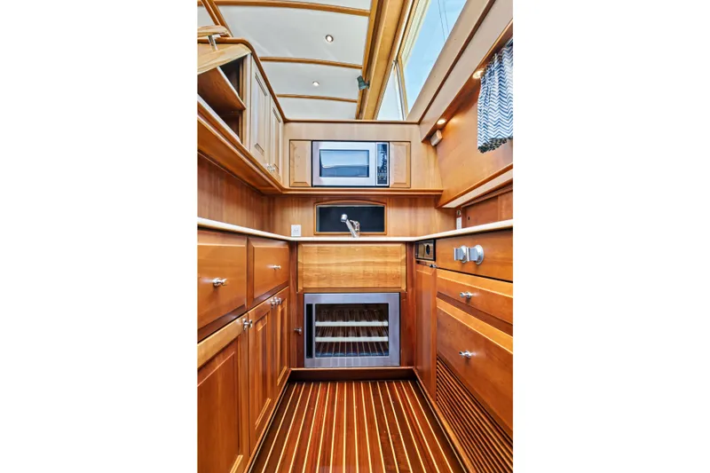 Slide: The Image of Luxurious wooden interior of 2007 Hinckley Talaria 55 yacht kitchen with modern appliances. - 7