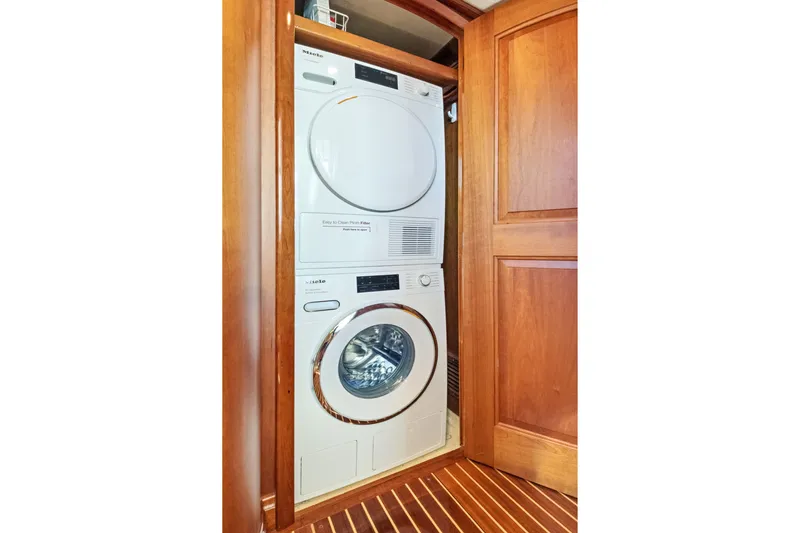Slide: The Image of Stacked washer and dryer in 2007 Hinckley Talaria 55 yacht's wooden interior. - 17