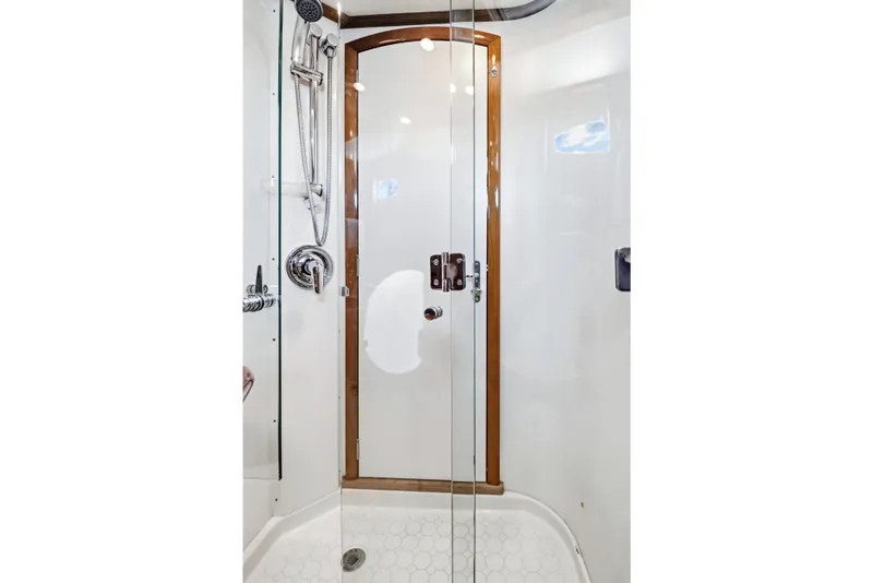 Slide: The Image of Shower area in 2007 Hinckley Talaria 55 yacht, featuring glass door and chrome fixtures. - 15