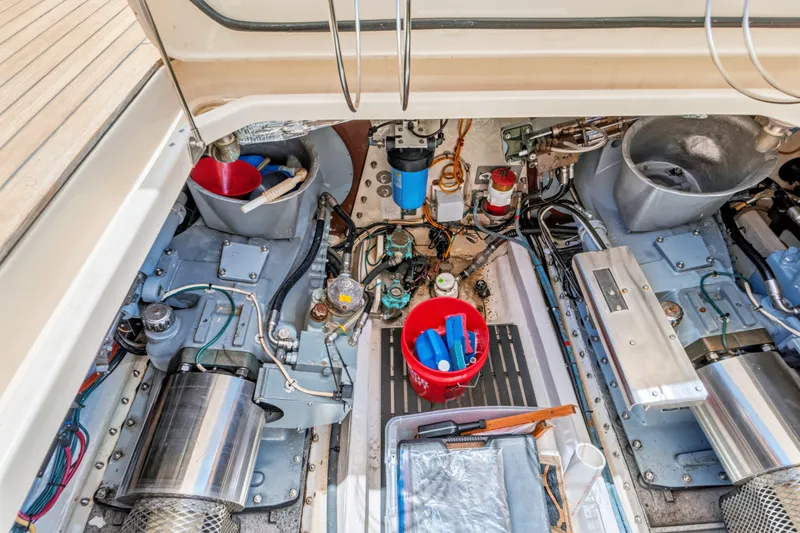 Slide: The Image of Engine room of a 2007 Hinckley Talaria 55 yacht, showcasing mechanical components and tools. - 54
