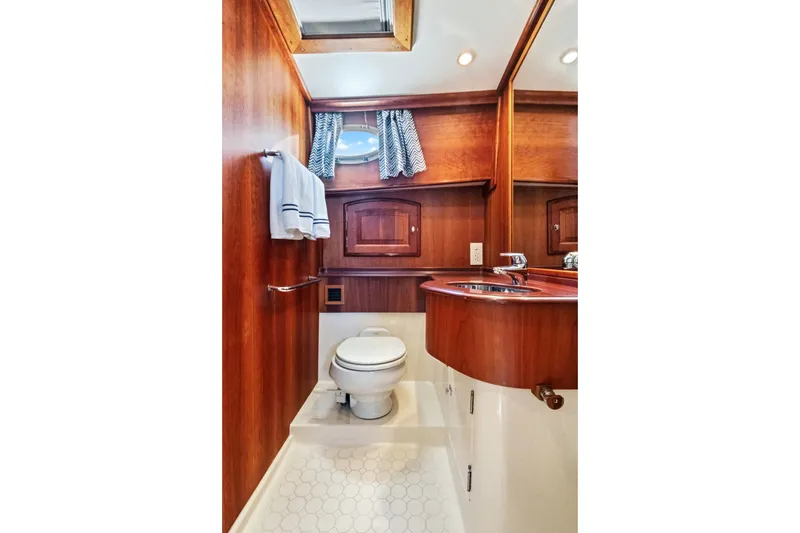 Slide: The Image of Luxurious wooden bathroom interior of 2007 Hinckley Talaria 55 yacht with toilet and sink. - 14