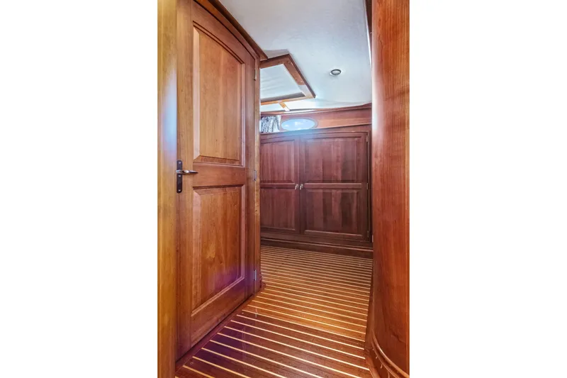 Slide: The Image of Luxurious wooden interior of 2007 Hinckley Talaria 55 yacht, featuring elegant cabinetry and flooring. - 16