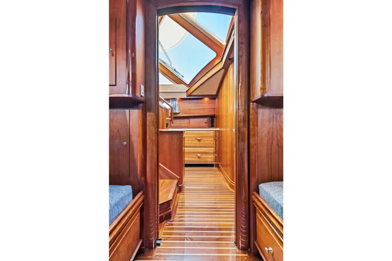 Slide: The Image of Interior of 2007 Hinckley Talaria 55 yacht, featuring elegant wood paneling and cabinetry. - 13