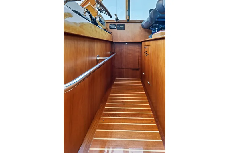 Slide: The Image of Interior view of 2007 Hinckley Talaria 55 yacht, showcasing polished wood paneling and flooring. - 30