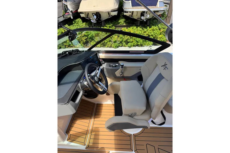 Slide: The Image of 2027 MasterCraft XT23 boat interior with steering wheel and captain's seat. - 4