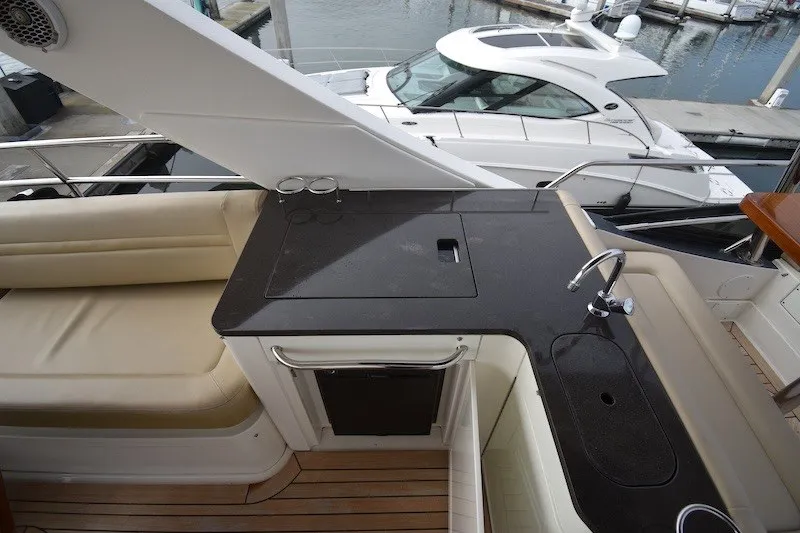 Slide: The Image of 2015 Sea Ray 510 Fly yacht with sleek outdoor kitchen and seating area. - 30
