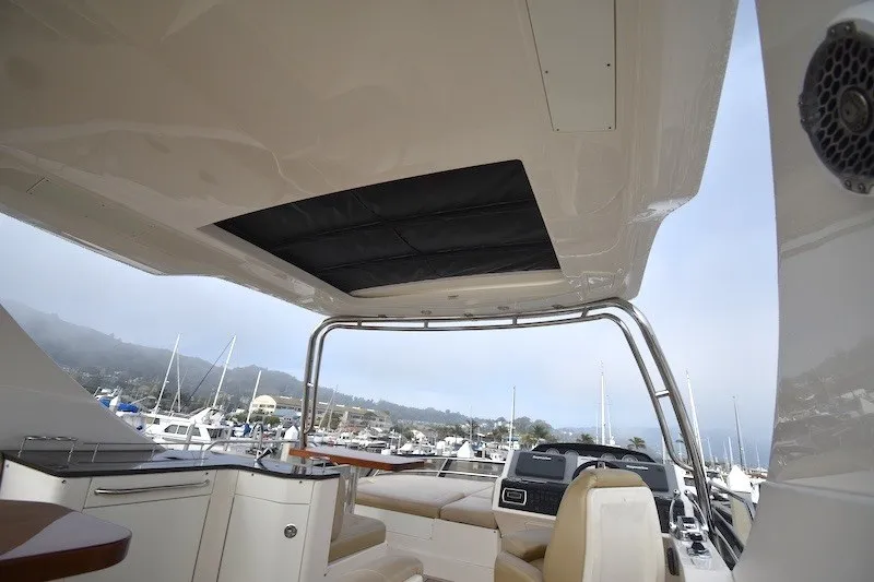 Slide: The Image of Flybridge view of 2015 Sea Ray 510 Fly yacht, featuring luxurious seating and marina backdrop. - 29