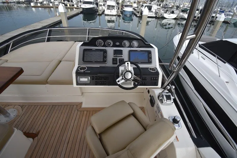 Slide: The Image of Flybridge helm of 2015 Sea Ray 510 Fly yacht with marina view. - 31