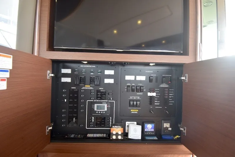 Slide: The Image of Electrical control panel inside 2015 Sea Ray 510 Fly yacht, featuring switches and meters. - 24
