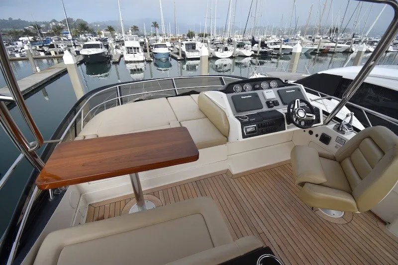 Slide: The Image of Luxurious 2015 Sea Ray 510 Fly yacht interior with helm, seating, and marina view. - 28