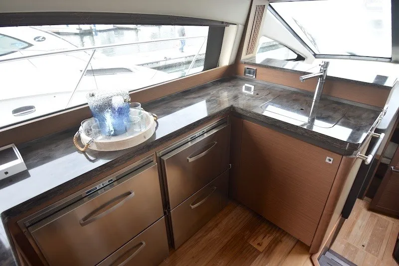 Slide: The Image of Luxurious kitchen area in a 2015 Sea Ray 510 Fly yacht with modern amenities. - 14