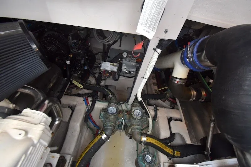Slide: The Image of Engine room of 2015 Sea Ray 510 Fly, showcasing mechanical components and piping. - 35