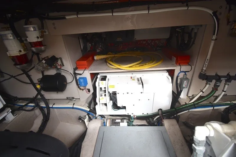 Slide: The Image of Engine room of 2015 Sea Ray 510 Fly yacht, showcasing mechanical components and wiring. - 32