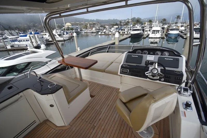 Slide: The Image of Flybridge of 2015 Sea Ray 510 Fly yacht with helm, seating, and marina view. - 26