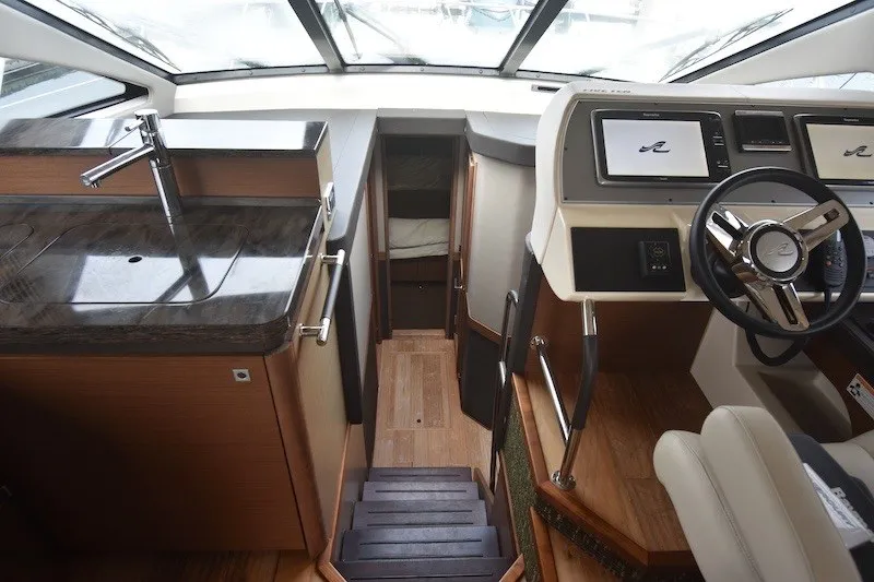 Slide: The Image of Interior of 2015 Sea Ray 510 Fly yacht with helm, stairs, and kitchenette. - 15