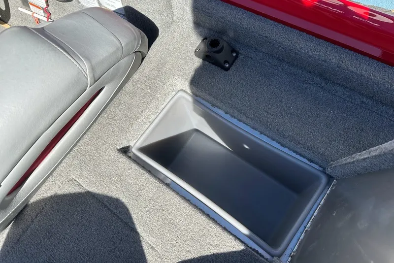 Slide: The Image of 2012 Tracker Pro Team 175 TXW boat interior storage compartment with gray upholstery. - 25