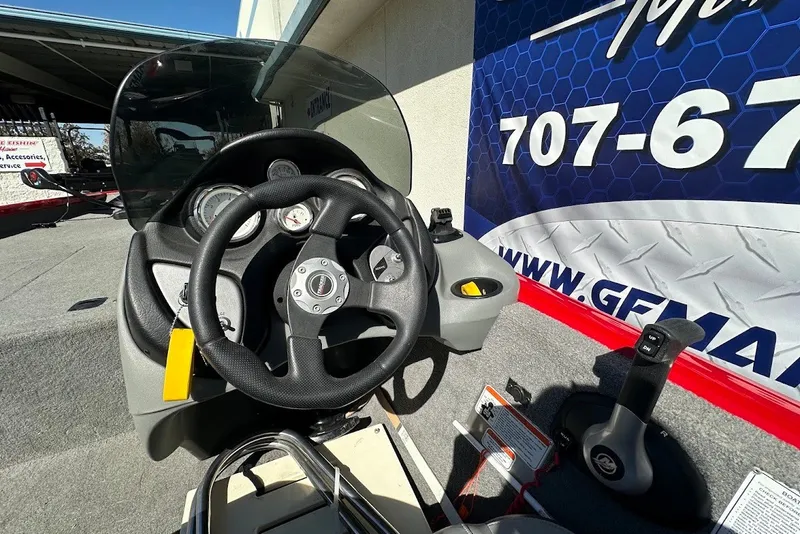 Slide: The Image of Steering console of 2012 Tracker Pro Team 175 TXW boat, featuring gauges and controls. - 13