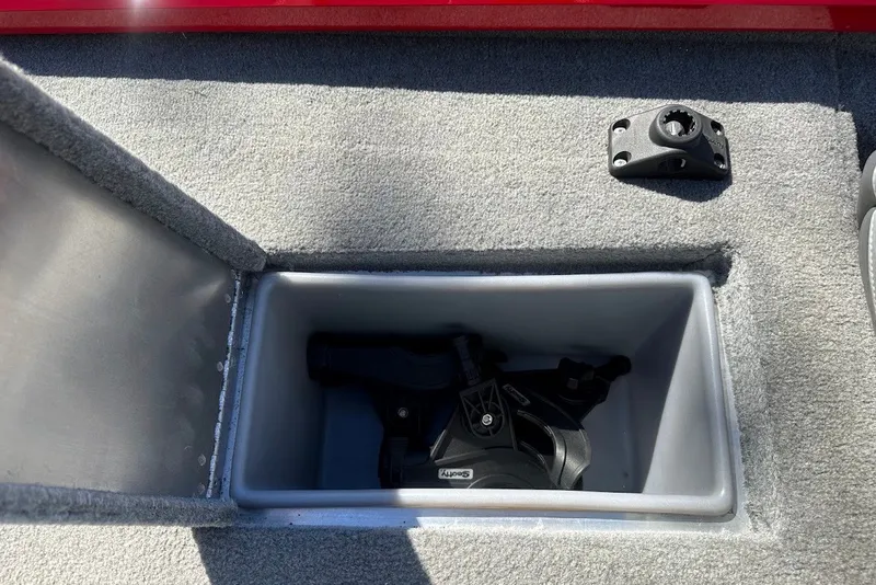 Slide: The Image of Storage compartment in 2012 Tracker Pro Team 175 TXW boat, featuring a Scotty rod holder. - 23