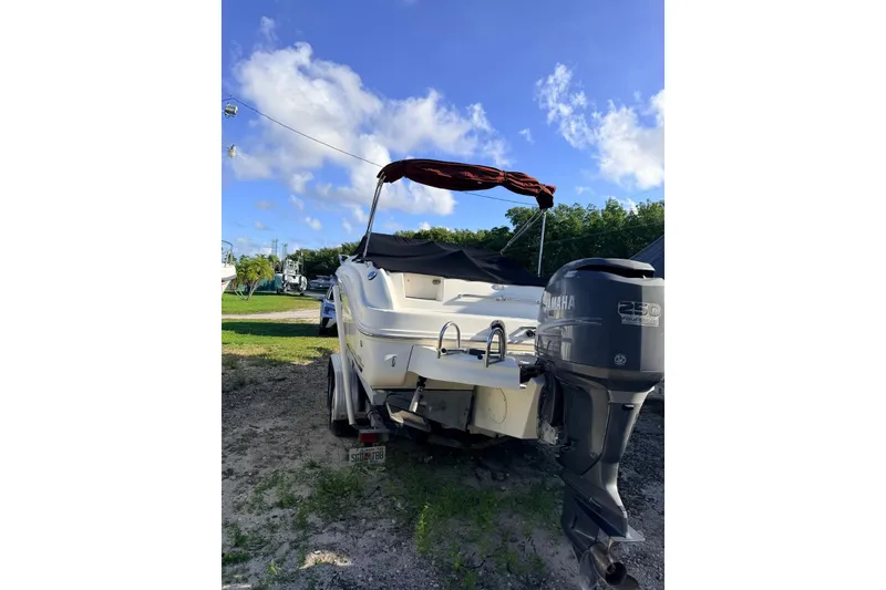 Slide: The Image of 2002 Sea Ray 225 Weekender boat with Yamaha 250 outboard motor, parked outdoors. - 3